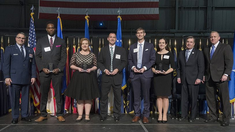 Recipients of the Air Force Research Laboratory Science and Engineering Early Career Award pose with Maj. Gen. William Cooley, AFRL commander, and Dr. Morley O. Stone, AFRL chief technology officer, during the AFRL Fellows and Early Career Awards Ceremony Oct. 26, 2017, at the National Museum of the Air Force, Wright-Patterson Air Force Base, Ohio. The award recognizes young scientists and engineers for exceptional leadership potential and mission contributions early in their research careers. (U.S. Air Force photo by R.J. Oriez)