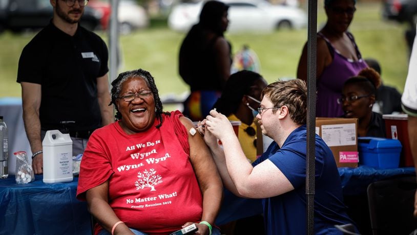Marlene Alexander, a resident of Desoto Bass, gets her COVID-19 vaccine from the ZIKS Pharmacy booth at a community fair held June 23, 2021.