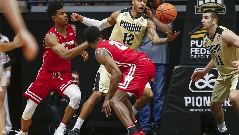 WEST LAFAYETTE, IN - JANUARY 16: Vincent Edwards #12 of the Purdue Boilermakers reaches for the ball against Aleem Ford #2 of the Wisconsin Badgers at Mackey Arena on January 16, 2018 in West Lafayette, Indiana. (Photo by Michael Hickey/Getty Images)