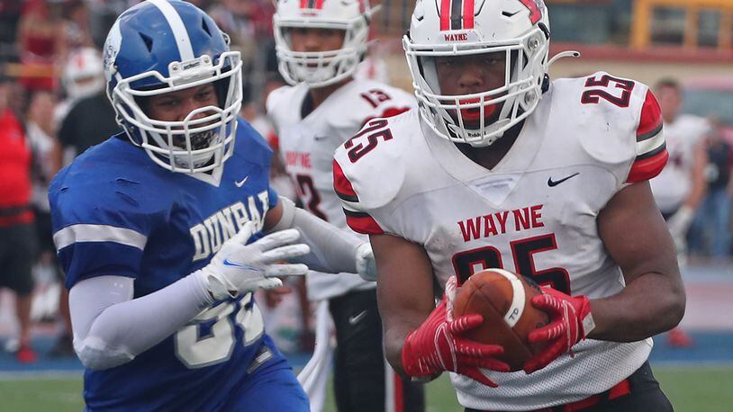 Wayne's Jordan Ward carries the ball in for a touchdown against Dunbar during Friday's game. BILL LACKEY/STAFF