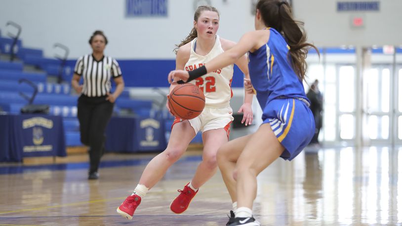 Cutline: Waynesville High School junior Isabella Cassoni drives past Mariemont's Kendall Spreen during their game on Saturday afternoon at Springfield High School. Cassoni scored 21 points as the Spartans won 33-29. Michael Cooper/CONTRIBUTED