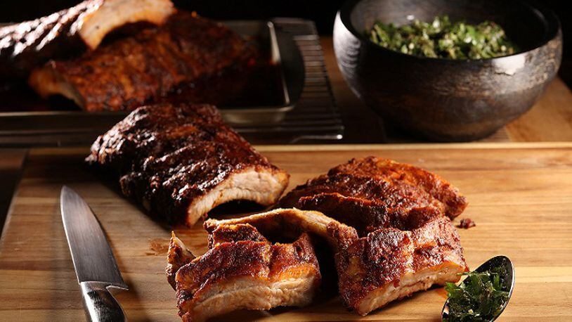A Spanish-inspired marinade of paprika, pounded garlic and olive oil lends an earthy depth to ribs made in the oven. (Abel Uribe/Chicago Tribune/TNS)