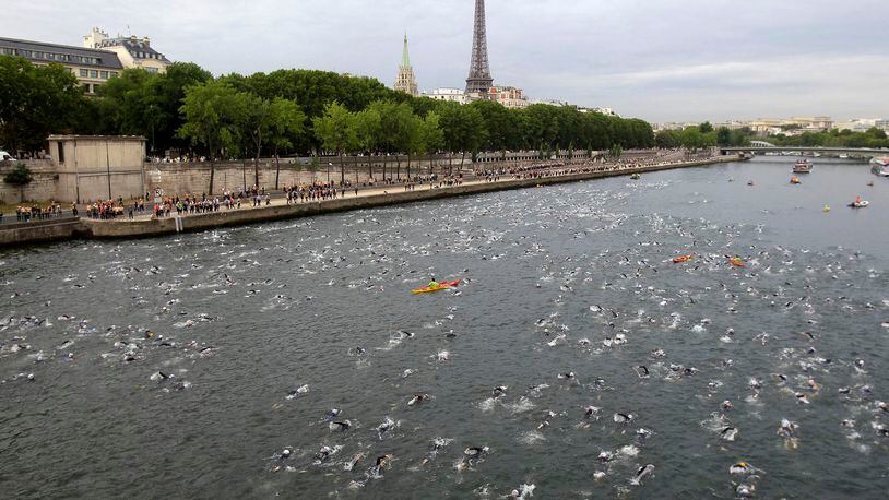 FILE - Competitors swim in the Seine River during the Paris Triathlon competition in Paris Sunday, July 10, 2011. Paris mayor Anne Hidalgo saidTuesday April 23, 2024 she was confident water quality will be up to the Olympics standards this summer _ and that she'll be able to prove it by swimming there, possibly alongside President Emmanuel Macron. (AP Photo/Lionel Cironneau, File )
