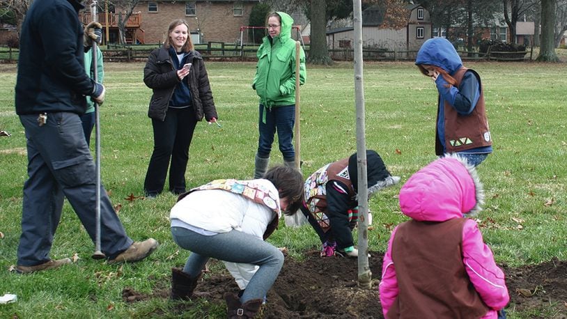 Centerville Brownie Troop #35288 assists Brian Sullivan, operations technician III of Centerville-Washington Park District, with planting a red maple in Village South Park on Dec. 22. Pictured, in back (from left): troop co-leader Amanda Venero, Brownie mom Natosha Remley; Brownies (from left): Riley Bakan, Evelyn Venero, Amelia Poharski and Lucy Remley. CONTRIBUTED