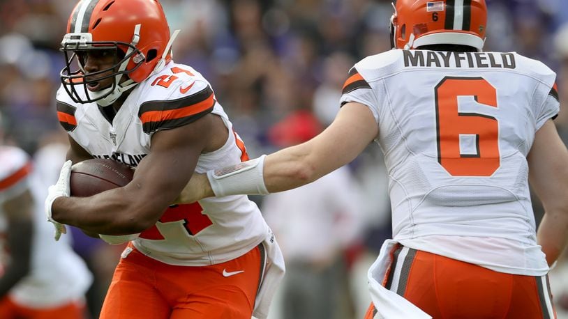 BALTIMORE, MARYLAND - SEPTEMBER 29: Quarterback Baker Mayfield #6 of the Cleveland Browns hands offsides to running back Nick Chubb #24 during the first quarter of the game against the Baltimore Ravens at M&T Bank Stadium on September 29, 2019 in Baltimore, Maryland. (Photo by Rob Carr/Getty Images)