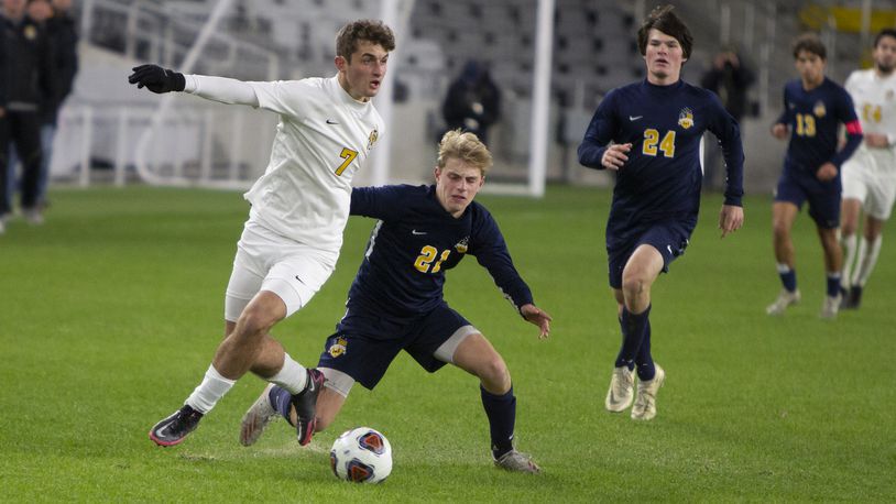 Centerville forward Jack Drabenstott (7) gets past Cleveland St. Ignatius defender Ernest Vargo on Saturday night in the Division I state final at Lower.com Field in Columbus. Jeff Gilbert/CONTRIBUTED