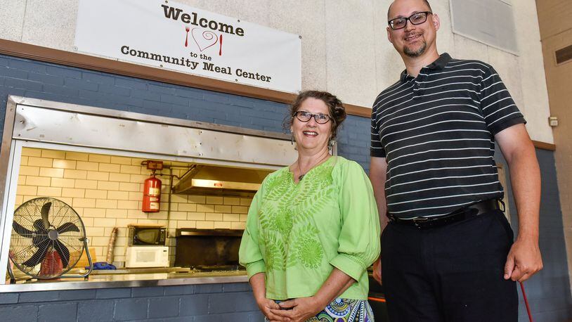 Lauren Marsh, director and president of Community Meal Center, stands with Joe Schrock, pastor of Zion Lutheran Church, stands inside Zion Lutheran Church that hosts a free dinner on Friday evenings. NICK GRAHAM/STAFF