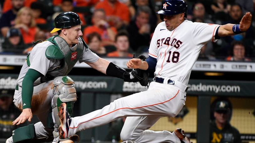 Houston Astros' Jason Castro (18) is tagged out at home by Oakland Athletics catcher Sean Murphy during the sixth inning of a baseball game, Saturday, Oct. 2, 2021, in Houston. (AP Photo/Eric Christian Smith)