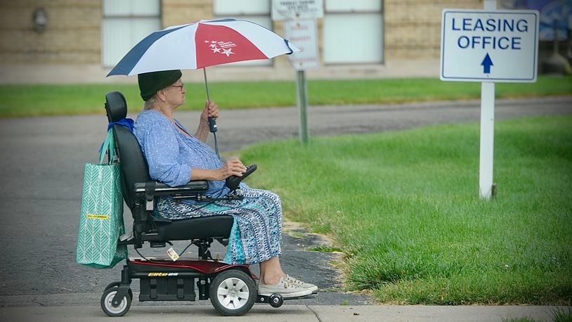 Carlene Strong is prepared for the rainy weather while heading to the store in Fairborn, Wednesday, June 30, 2021. MARSHALL GORBY\STAFF