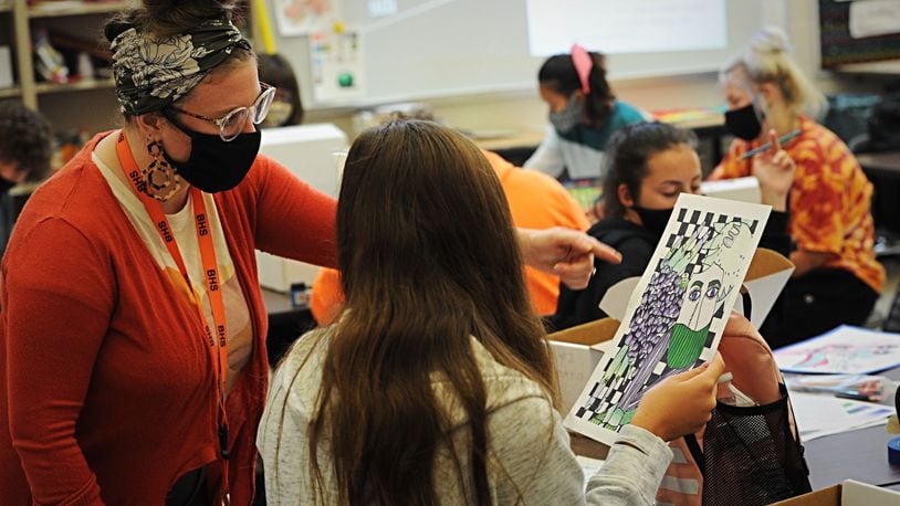 A Beavercreek High School teacher works with art students on Oct. 8, 2020.