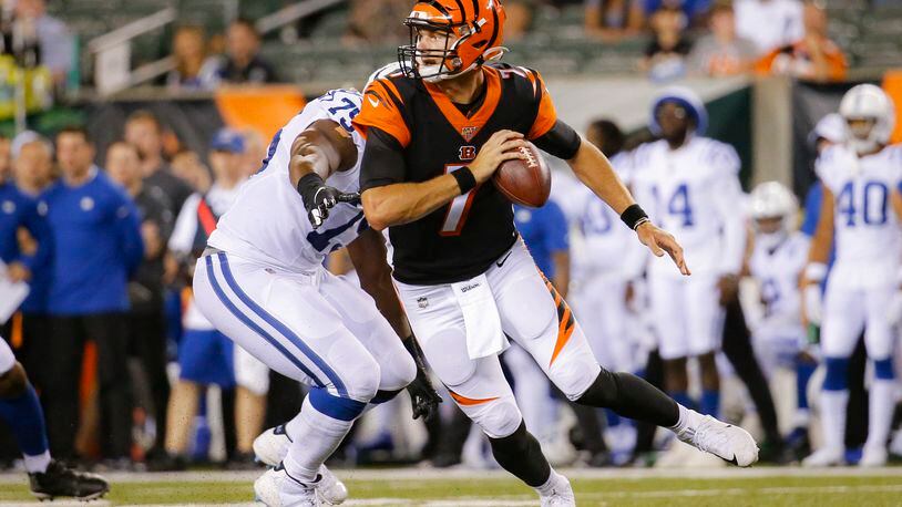 Cincinnati Bengals quarterback Jake Dolegala (7) looks to pass under pressure by Indianapolis Colts defensive tackle Caraun Reid (75) during the second half of an NFL preseason football game, Thursday, Aug. 29, 2019, in Cincinnati. (AP Photo/Frank Victores)