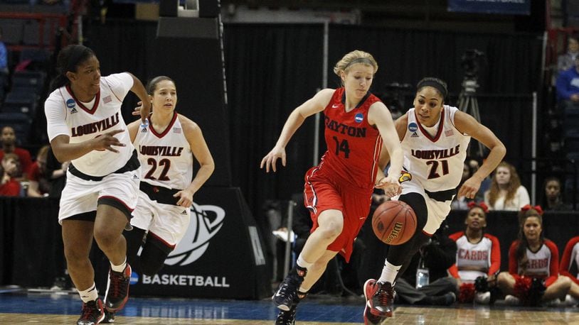 Dayton’s Jenna Burdette tries to elude three Louisville defenders in the third round of the NCAA tournament on Saturday, March 28, 2015, at the Times Union Center in Albany, N.Y. David Jablonski/Staff