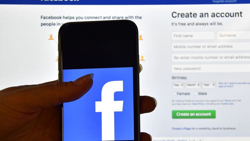 Some users say Facebook is posting their old photos like new ones and without their permission. (Photo by Carl Court/Getty Images)