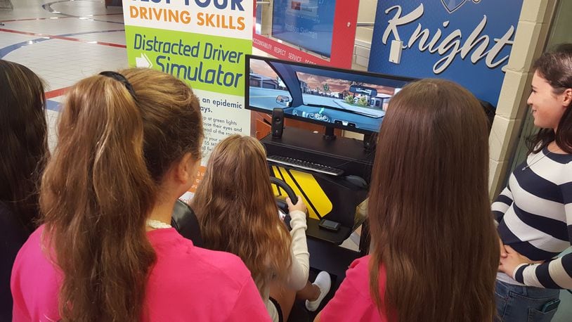 Kings High School students try out a simulator during a special event set up by the Ohio Department of Transportation as part of efforts to reduce teen crashes.