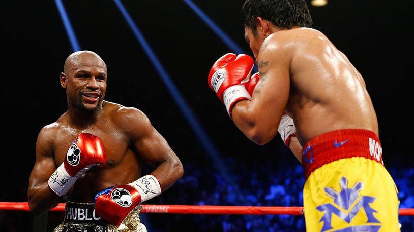 LAS VEGAS, NV - MAY 02:  Floyd Mayweather Jr. smiles at Manny Pacquiao during their welterweight unification championship bout on May 2, 2015 at MGM Grand Garden Arena in Las Vegas, Nevada.  (Photo by Al Bello/Getty Images)