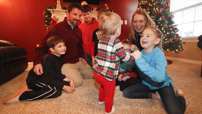 Christie and Brian Looney of Huber Heights helped a drug-exposed baby through withdrawal after becoming foster parents in 2015. Their third foster child, pictured, a 19-month-old, will soon become their adopted daughter and sister to their five biological children: Mason, 13, Myles, 11, Max, 10, Mae, 9, and Maddie, 4. CHRIS STEWART / STAFF