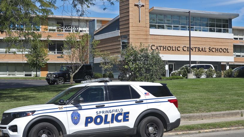 A Springfield police cruiser sits in front of Catholic Central School. BILL LACKEY/STAFF