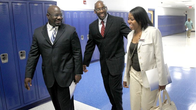 In this file photo, Larry Ballew (left), then dean of Dunbar High School, gives a tour to Angela Davis (right), a school community partner from Office Depot along with David Lawrence (center), then chief of school innovation at Dayton Public Schools. LISA POWELL / STAFF