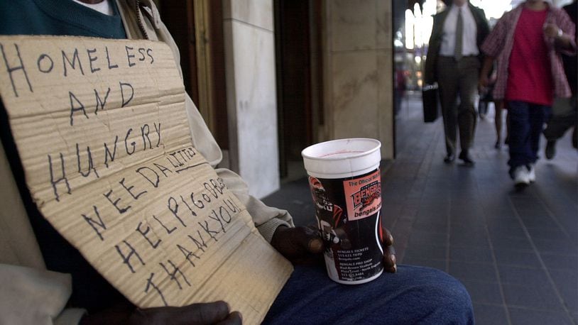 A panhandler begs for money December 5, 2001 in downtown Cincinnati. The city of Cincinnati is trying to come up with ways to combat the problem of panhandling which they say is keeping people from coming downtown to do their Christmas shopping. (Photo by Mike Simons/Getty Images)
