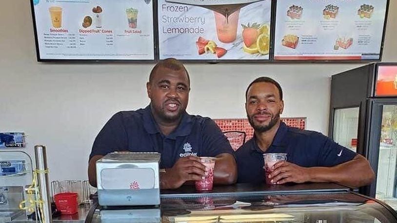 Chad Diggs, left, and Trenton Nalls are co-franchise owners of the Edible Arrangements store that just relocated from Far Hills Avenue in Kettering to 2665 S. Dixie Drive in Kettering. SUBMITTED