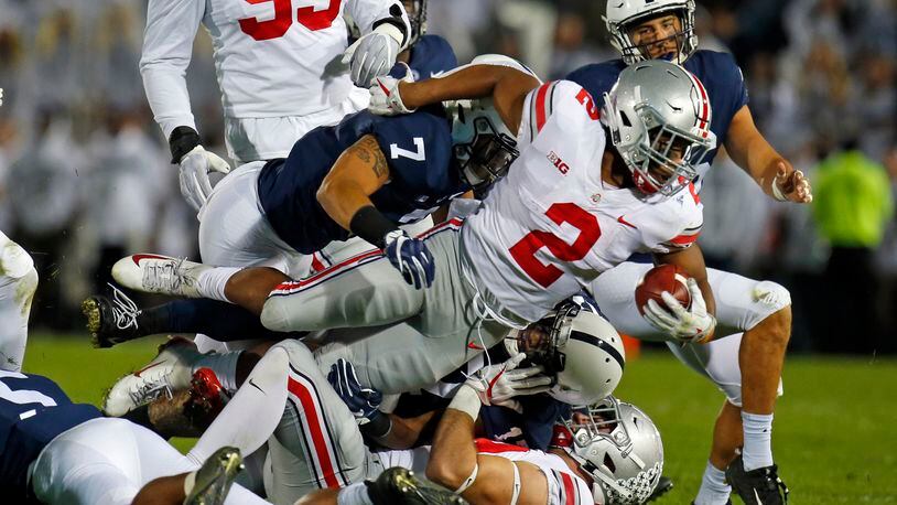 STATE COLLEGE, PA - SEPTEMBER 29: J.K. Dobbins #2 of the Ohio State Buckeyes is tackled by Koa Farmer #7 of the Penn State Nittany Lions on September 29, 2018 at Beaver Stadium in State College, Pennsylvania. (Photo by Justin K. Aller/Getty Images)