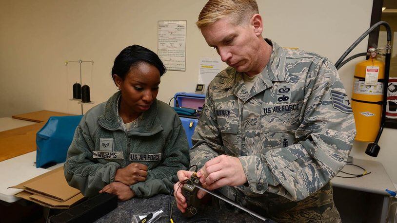 Airman Tabitha Williams, 403rd OSS aircrew flight equipment journeyman, on how to assemble and inspect an AN/URT-44 personnel locator beacon Jan. 10, 2015. The Air Force Life Cycle Management Center’s Agile Combat Support Directorate is currently fielding 12,000 new personnel locator beacons to replace the URT-44. (U.S. Air Force photo)