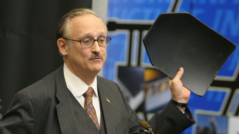 John Prikkel III, president of Liteflex LLC, with a composite plate made for body armour by his company. Photo by Ed Roberts