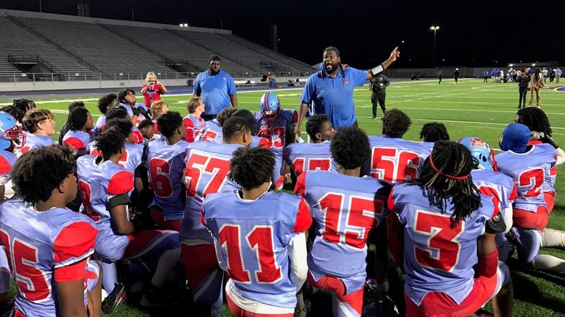 Belmont head coach Maurice Vaughn talks to his team after its first win of the season, a 20-6 victory over Ponitz in the Bison’s Homecoming Game at Welcome Stadium. Tom Archdeacon/CONTRIBUTED