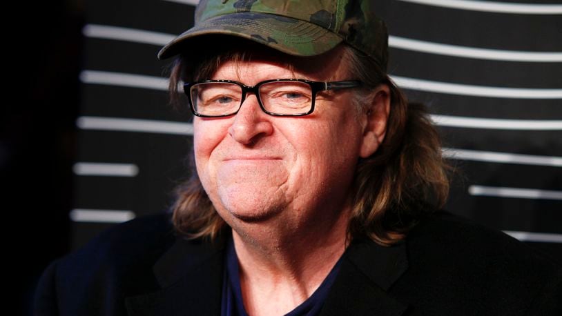 FILE - In this May 16, 2016 file photo, Michael Moore attends the 20th Annual Webby Awards at Cipriani Wall Street in New York. Moore premiered a surprise film about the U.S. presidential election on Tuesday, Oct. 18, 2016. "Michael Moore in TrumpLand" features a one-man stage show of Moore discussing the race. (Photo by Andy Kropa/Invision/AP, File)