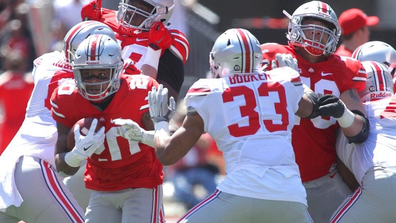 Mike Weber (20) and Dante Booker (33) are a pair of Ohio State players who could join the starting lineup for the first time this fall. David Jablonski/Staff