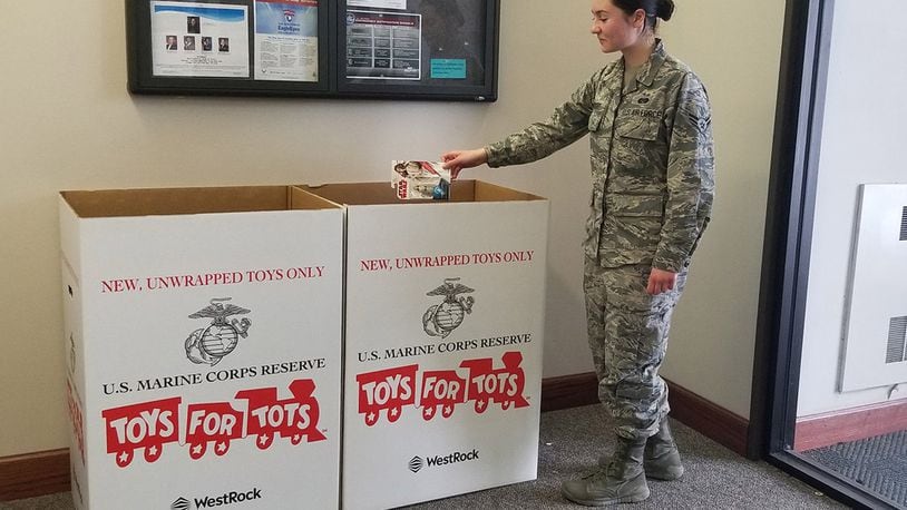 Airman 1st Class Haley Wright, a paralegal in the 88th Air Base Wing’s Judge Advocate office, donates a toy for the 2019 Marine Corps Toys for Tots campaign at Wright-Patterson Air Force Base. New, unwrapped toys may be donated until Dec. 13. (U.S. Air Force photo/Pamela Piccoli)