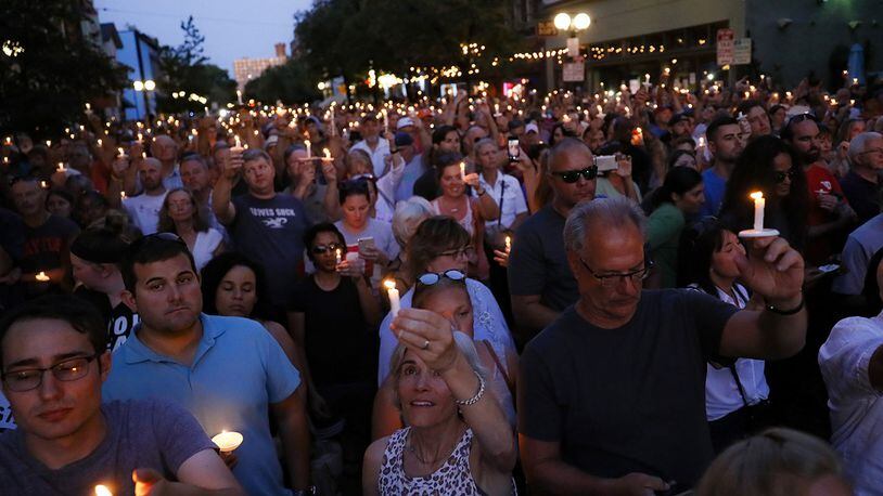 Mourners gather for a vigil at the scene of a mass shooting, Sunday, Aug. 4, 2019, in Dayton, Ohio. Multiple people in Ohio were killed in the second mass shooting in the U.S. in less than 24 hours.