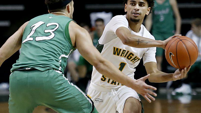 Wright State guard Trey Calvin looks to pass around Marshall guard Jarrod West during a mens basketball game at the Nutter Center in Fairborn Thursday, Dec. 3, 2020. (E.L. Hubbard for the Dayton Daily News)