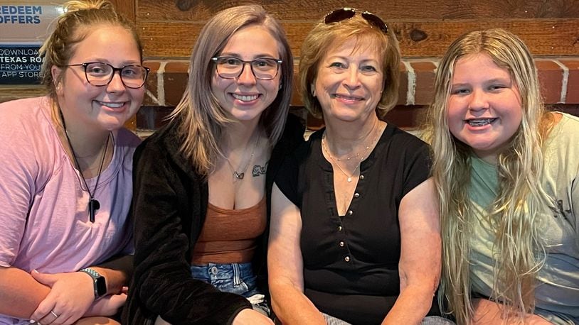 Barbara Pelfrey, (Second from right) chairman of the board of directors and long time volunteer for the Dyslexia Center of Dayton, shown with granddaughters, (L-R) Maggie Cassano, Carlee Cassano and Lucy Cassano. Pelfrey's grandchildren, especially Lucy, inspired her to become involved with the Center. CONTRIBUTED
