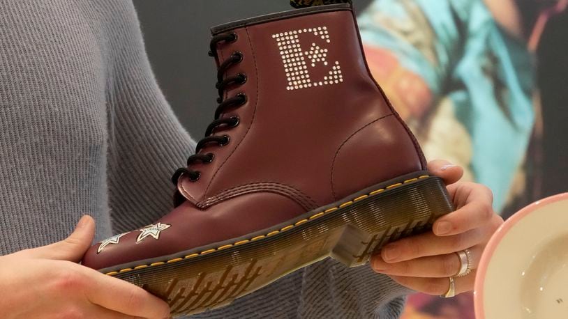 FILE - A Dr Martens boot inspired by Elton John's famous Pinball Wizard outfit is shown at a promotional event in London, March 20, 2023. Dr. Martens shares plunged more than 30% Tuesday, April 16, 2024 after the trendy British brand forecast that wholesale revenue in the U.S., its largest market, would decline by double-digits compared to that seen a year ago. (AP Photo/Kin Cheung, File)