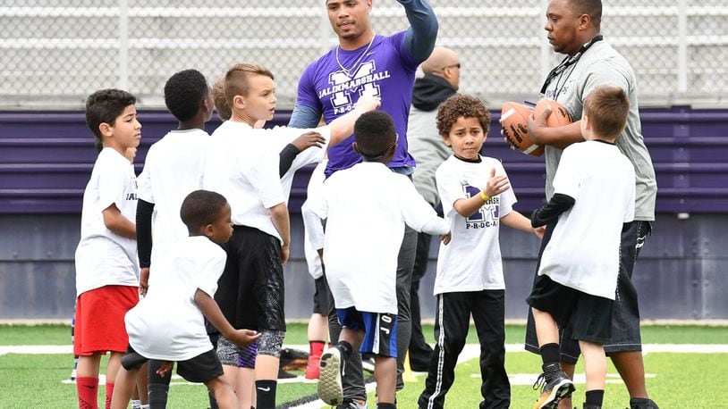 Former Middletown star and current New York Jet receiver Jalin Marshall leads a huddle with area elementary school students during a football camp on Sunday afternoon at Barnitz Stadium. Contributed Photo by Bryant Billing