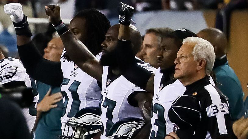 CHICAGO, IL - SEPTEMBER 19: Philadelphia Eagles players hold up a salute during the national anthem prior to the game against the Chicago Bears at Soldier Field on September 19, 2016 in Chicago, Illinois. (Photo by Jonathan Daniel/Getty Images)