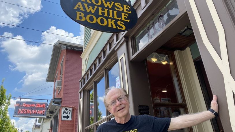 Bill Jones, owner of Browse Awhile Books, stands outside his shop in Tipp City.