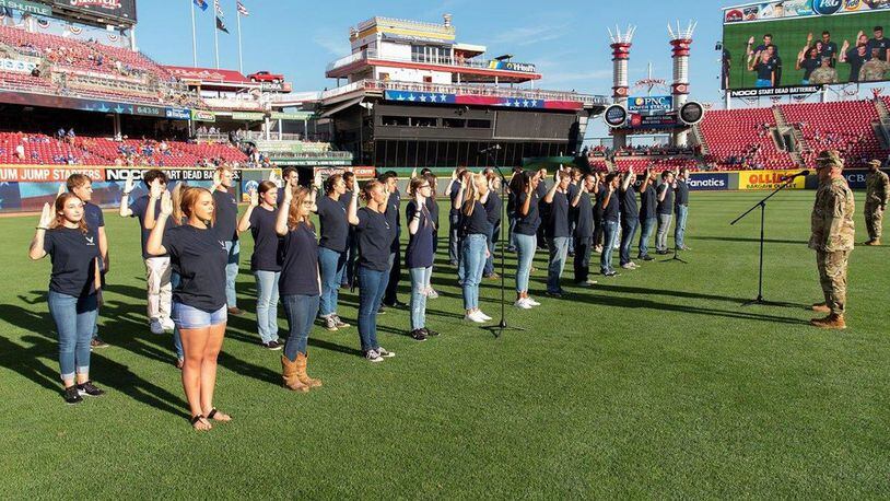 Participants in the U.S. Air Force’s Delayed Entry Program take the oath of enlistment Aug. 9 in a pregame ceremony presided over by Col. Thomas Sherman, 88th Air Base Wing and installation commander, at Great American Ball Park, Cincinnati, prior to a Reds-Cubs baseball game. The U.S. Air Force Band of Flight and the Wright-Patterson AFB Honor Guard also took part in pregame activities. (U.S. Air Force photo/R.J. Oriez)