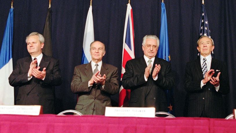 Serbian President Slobodan Milosevic, left, Bosnian President Alija Izetbegovic, Croatian President Franjo Tudjman and U.S. Secretary of State Warren Christopher applaud after initialing a pact after an agreement was reached, Nov. 21, 1995, at Wright-Patterson Air Force Base after 21 days at the Proximity Peace Talks in Dayton, Ohio.The U.S.-brokered accord, reached in Dayton, ended Bosnia's 1992-95 war between rival Muslim Bosniaks, Orthodox Serbs and Roman Catholic Croats, who clashed on the republic's future after the former Yugoslav federation fell apart. Milosevic is now on trial for war crimes in The Hague. Izetbegovic died of heart failure on Oct. 19, 2003, at the age of 78, and  Tudjman died in 1999.(AP Photo/Michael Heinz)