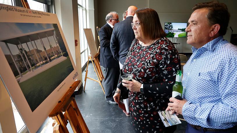 Alicia and Greg Hupp look over the artist's renderings showing what the renovated North Wing of the Springfield Museum of Art will look like following a ribbon cutting ceremony and reception celebrating the start of the multi-million dollar project Thursday, March 23, 2023. BILL LACKEY/STAFF