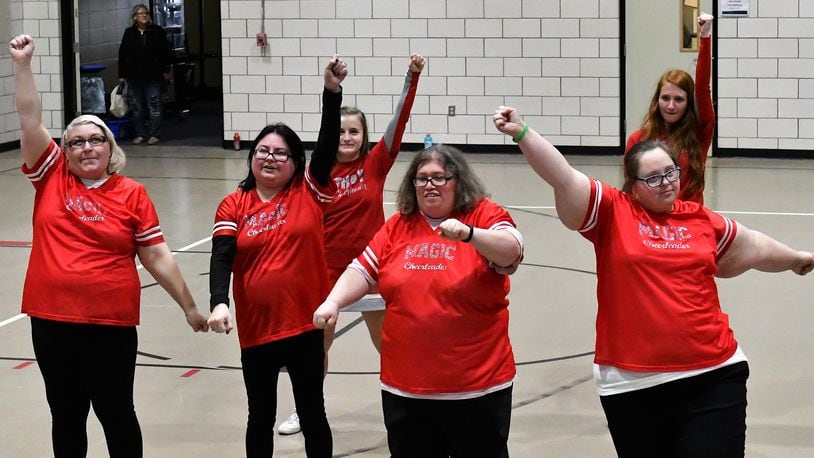 Cheerleaders from Troy High School (back row) take to the floor at Riverside (Miami County Board of Developmental Disabilities) with the Riverside Magic cheerleaders (front) for the annual Spirit Night basketball game on March 1. CONTRIBUTED