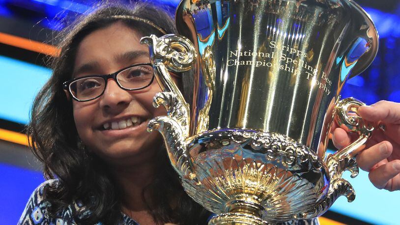 Ananya Vinay, 12, from Fresno, Calif., holds the trophy after being declared the winner of last year’s Scripps National Spelling Bee, in Oxon Hill, Md. The third round for this year’s bee begins Wednesday with 452 spellers still alive in the competition. (AP Photo/Manuel Balce Ceneta)