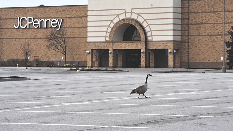A goose walks across the empty parking lot at the Mall at Fairfield Commons Tuesday. The mall is temporarily closed due to the spread of COVID-19. MARSHALL GORBYSTAFF
