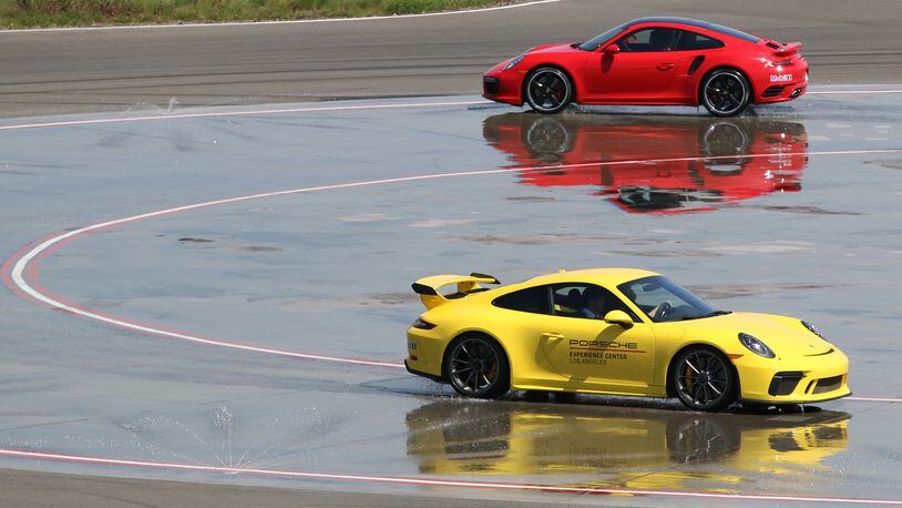 Drivers negotiate the Low-Friction Circle at the Porsche Experience Center Los Angeles on April 10, 2018. This course allows drivers to experience under and oversteer. The 53-acre facility is open to the public even if you don&apos;t own a Porsche. (Myung J. Chun/Los Angeles Times/TNS)