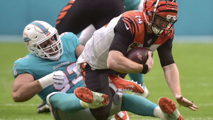 MIAMI, FLORIDA - DECEMBER 22: Zach Sieler #92 of the Miami Dolphins sacks Andy Dalton #14 of the Cincinnati Bengals in the first quarter of the game at Hard Rock Stadium on December 22, 2019 in Miami, Florida. (Photo by Eric Espada/Getty Images)