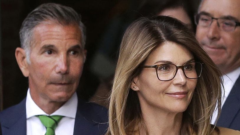 In this April 3, 2019, file photo, actress Lori Loughlin, front, and husband, clothing designer Mossimo Giannulli, left, leave federal court in Boston after facing charges in a nationwide college admissions bribery scandal.