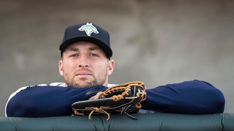 Tim Tebow looks out from the Columbia Fireflies dugout.