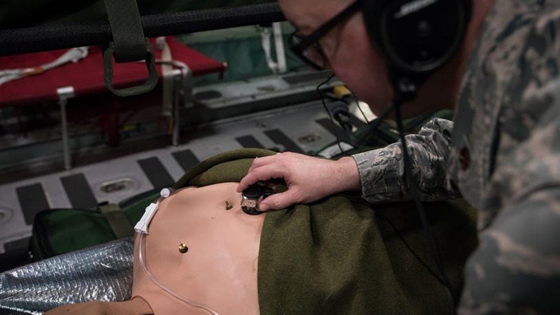While testing the new stethoscope, Maj. Daniel Bevington, a nurse researcher in the 711th Human Performance Wing of Air Force Research Laboratory, places the device on a mannequin’s chest to listen to internal sounds. (U.S. Air Force photos/Richard Eldridge)