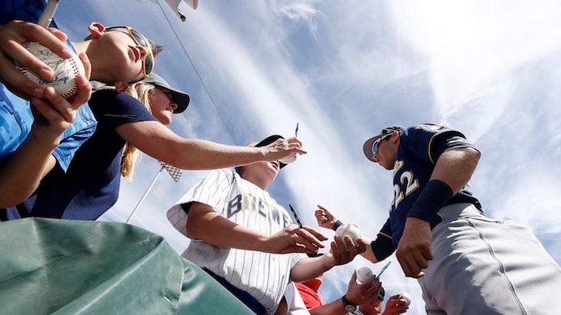 Milwaukee Brewers' Christian Yelich signs autographs for fans prior to a spring training baseball game against the Chicago White Sox Tuesday, March 6, 2018, in Glendale, Ariz. The White Sox defeated the Brewers 6-4. (AP Photo/Ross D. Franklin)